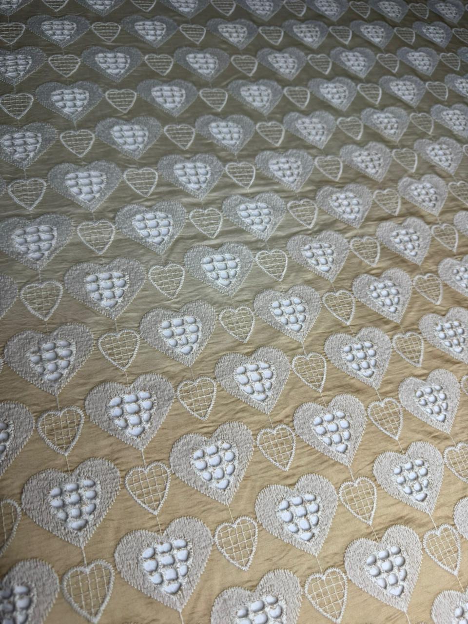 Textile with heart pattern on a beige background