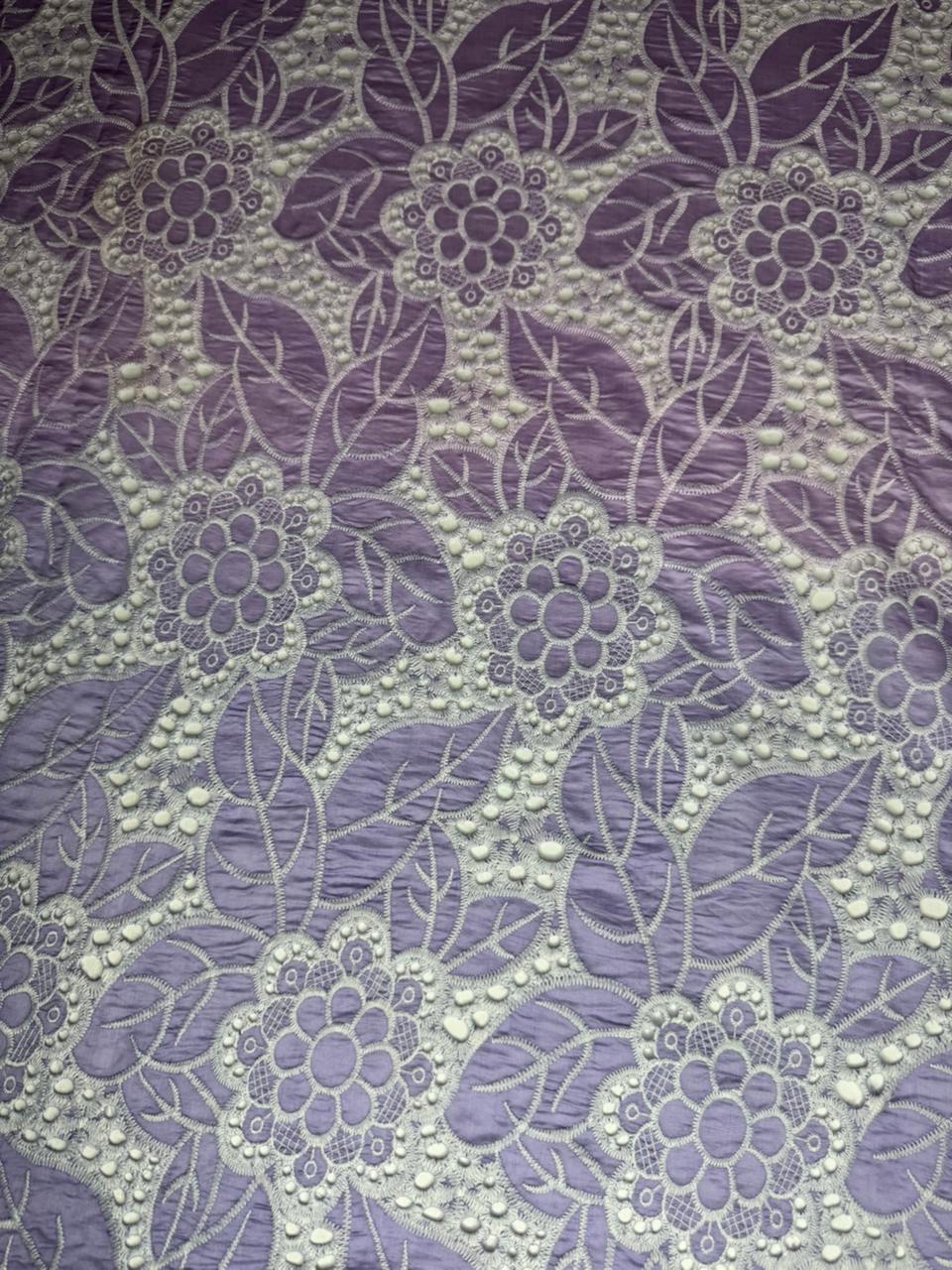 Floral pattern with purple flowers and leaves on a textured background