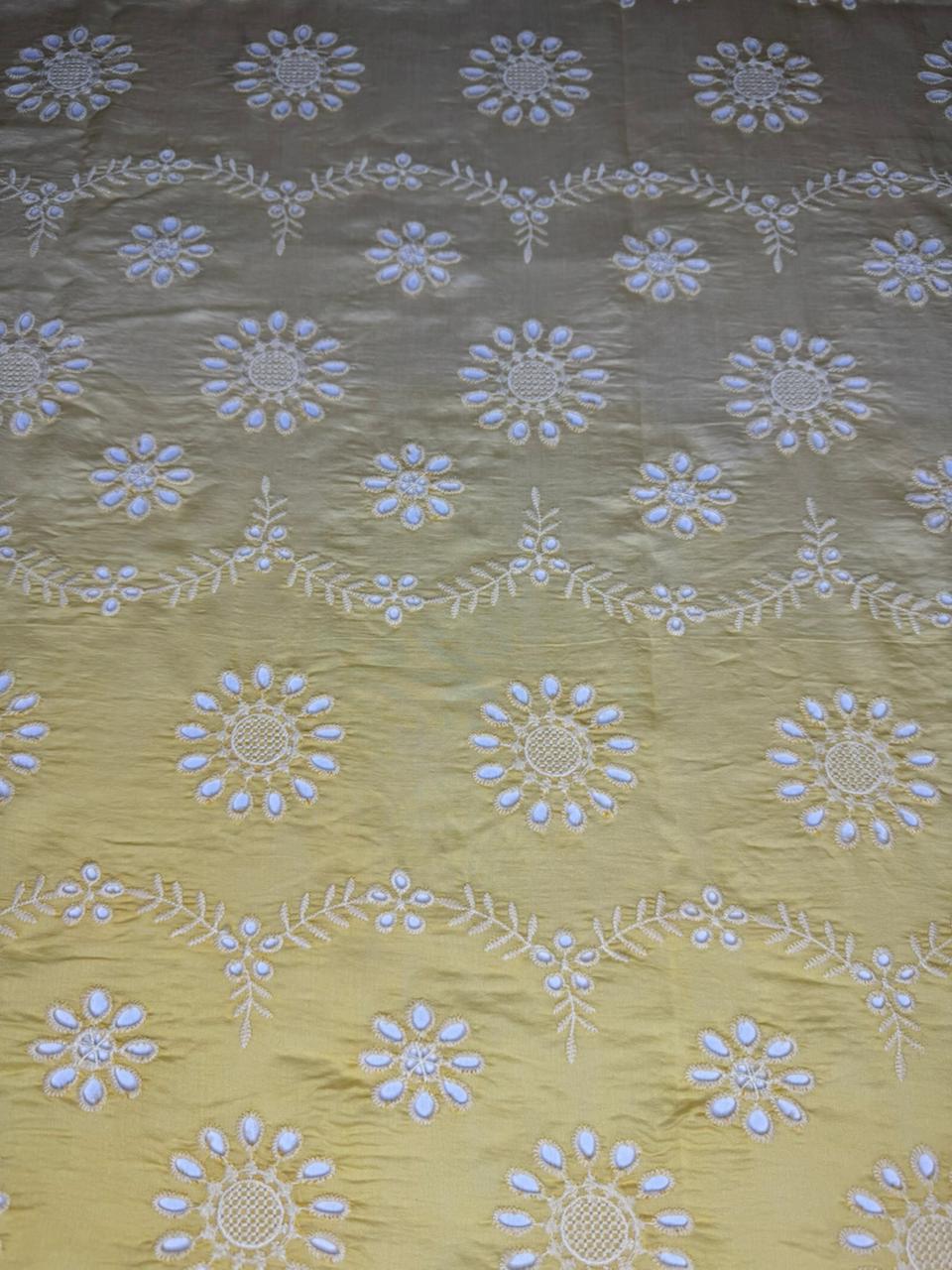 Textile with floral embroidery pattern on a green background