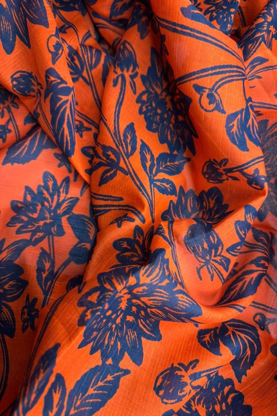 Orange fabric with blue floral patterns