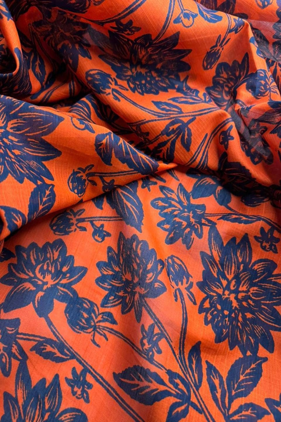 Orange fabric with blue floral pattern