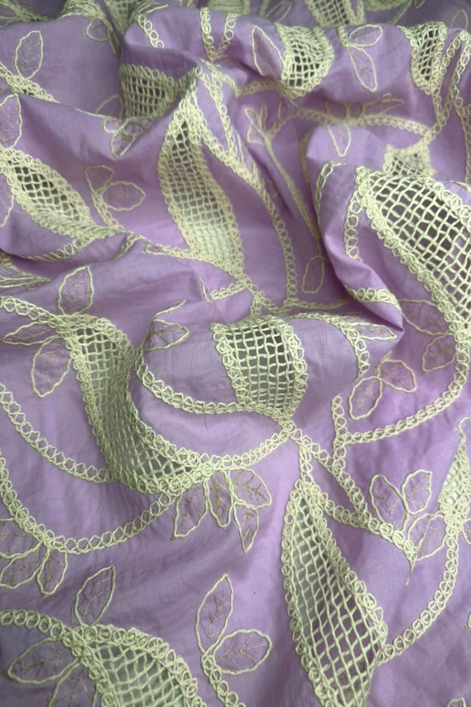 Purple fabric with green embroidered patterns