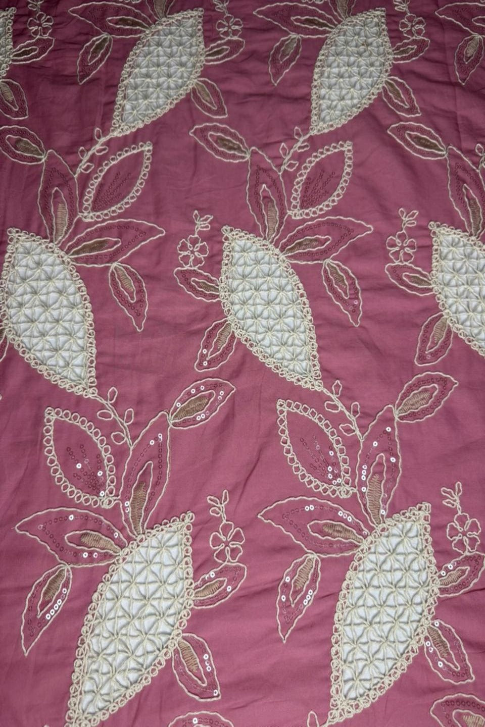 Decorative fabric with leaf pattern on a maroon background