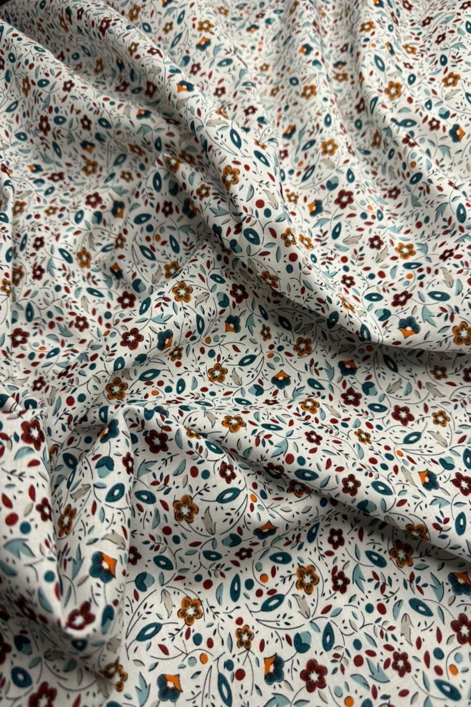 Floral patterned fabric with small flowers on a light background