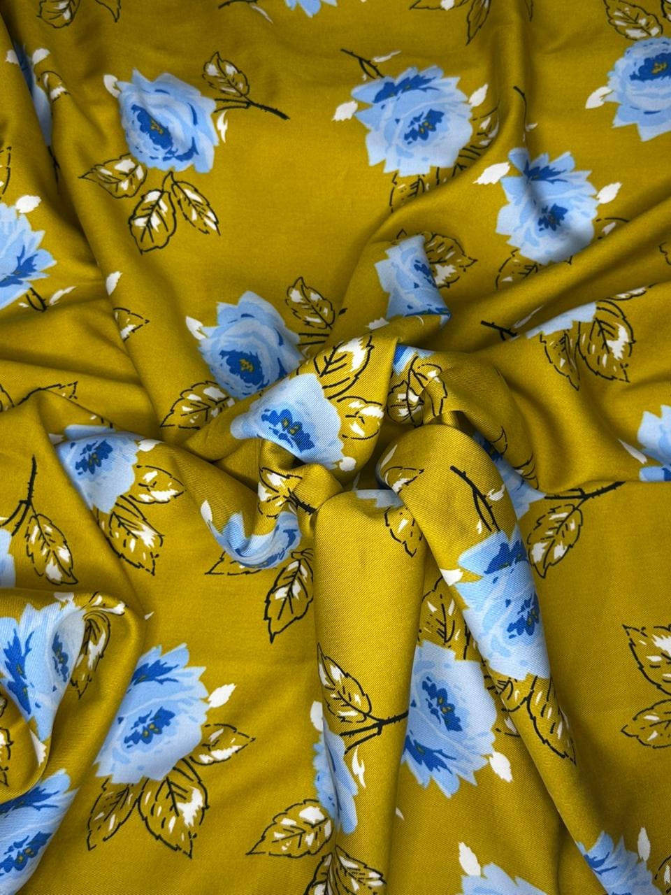 Yellow fabric with blue floral patterns