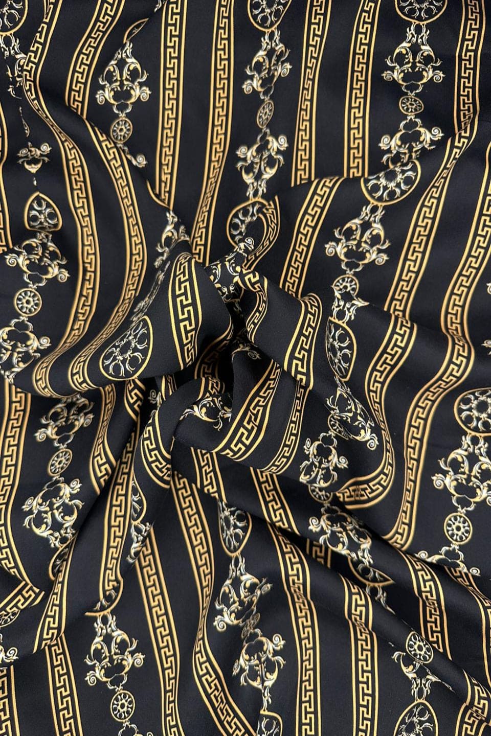 Close-up of black fabric with gold decorative patterns