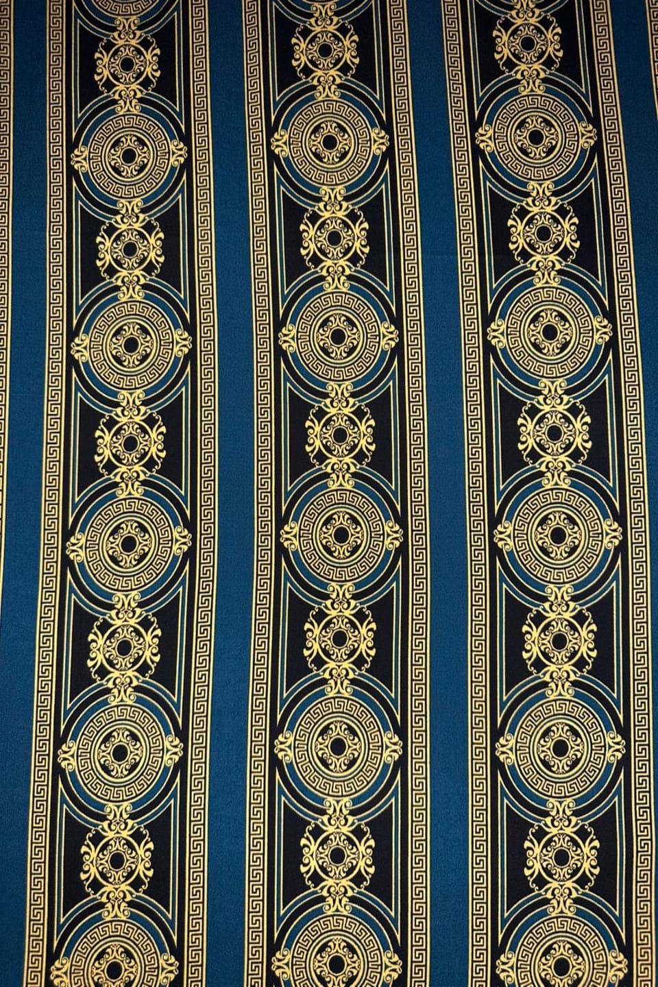 Decorative fabric with gold and black pattern on a blue background