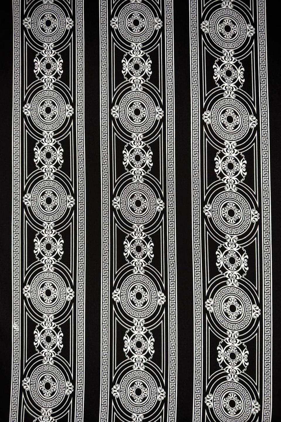 black and white patterned border on a black background