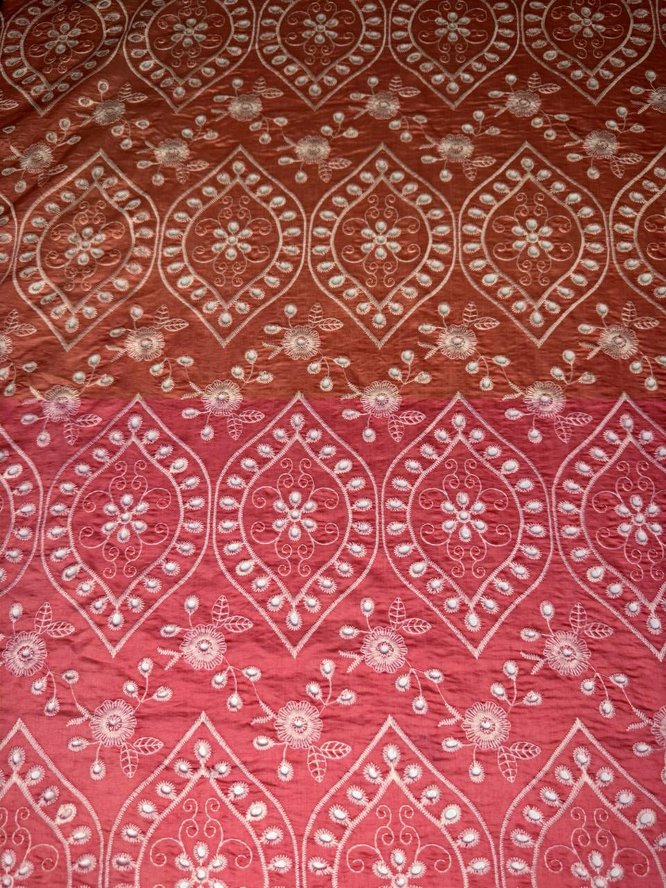 Red fabric with white floral and geometric pattern