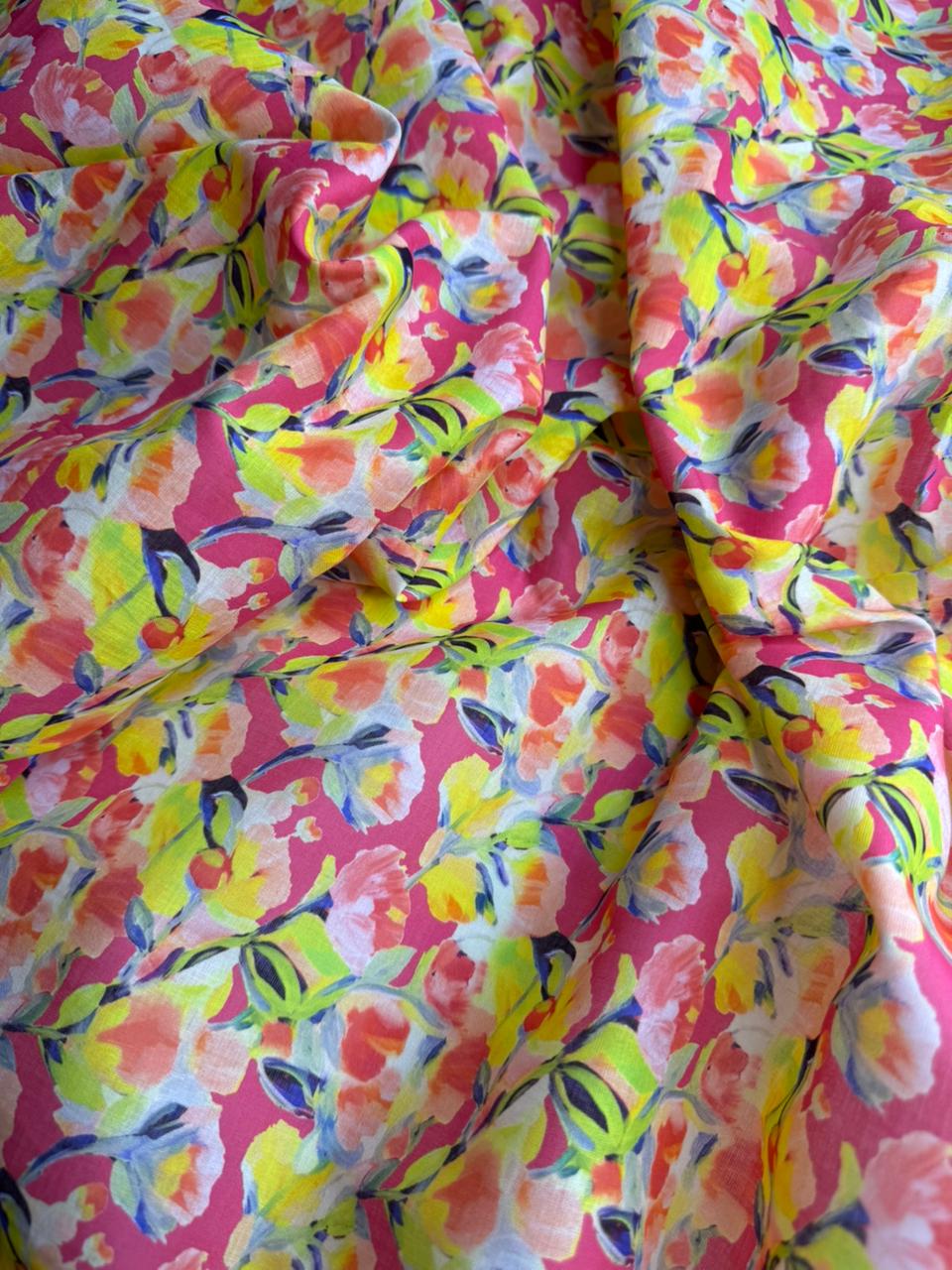 Colorful floral fabric with pink, yellow, and green patterns.