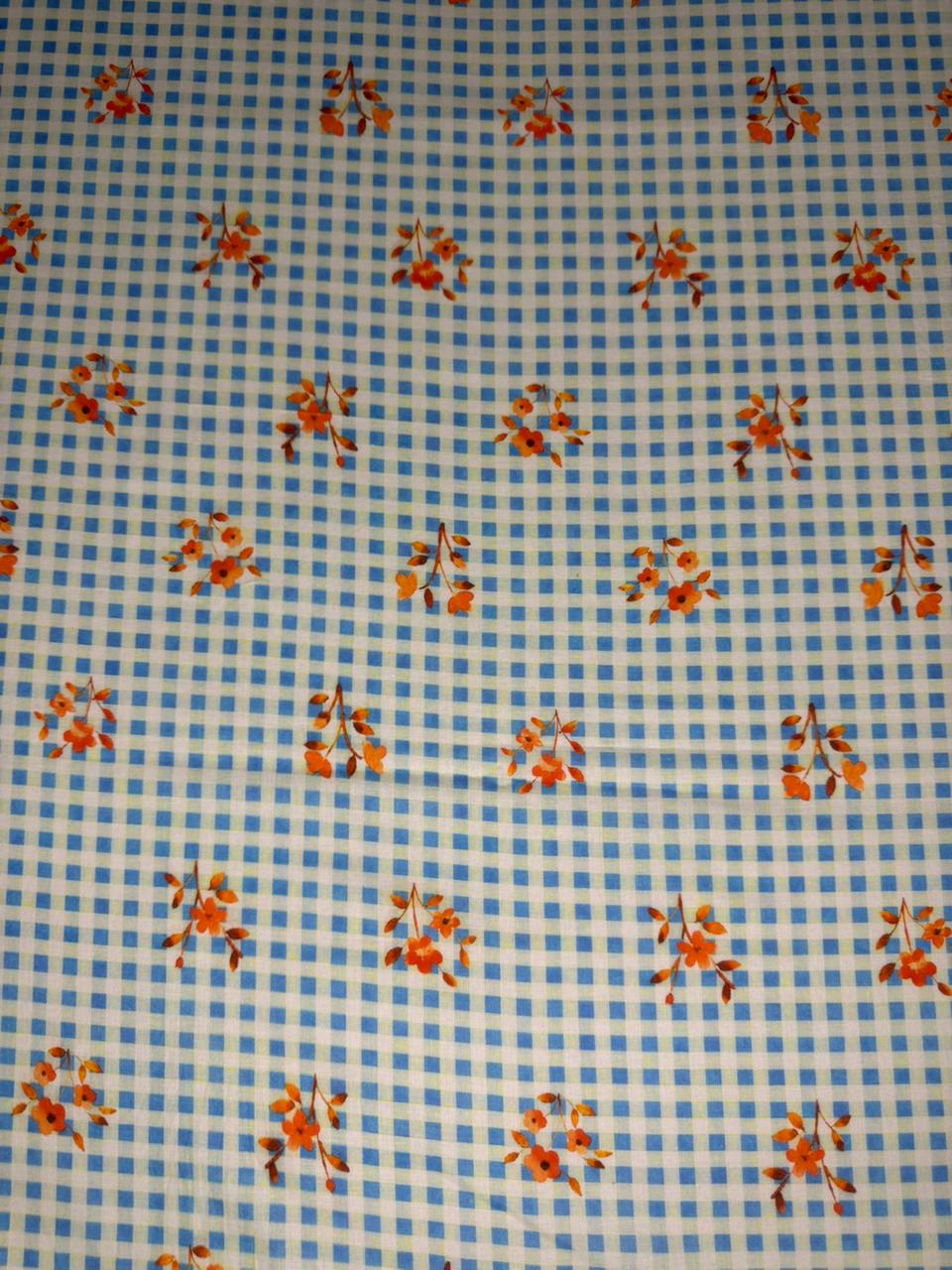 Blue checkered fabric with orange floral patterns
