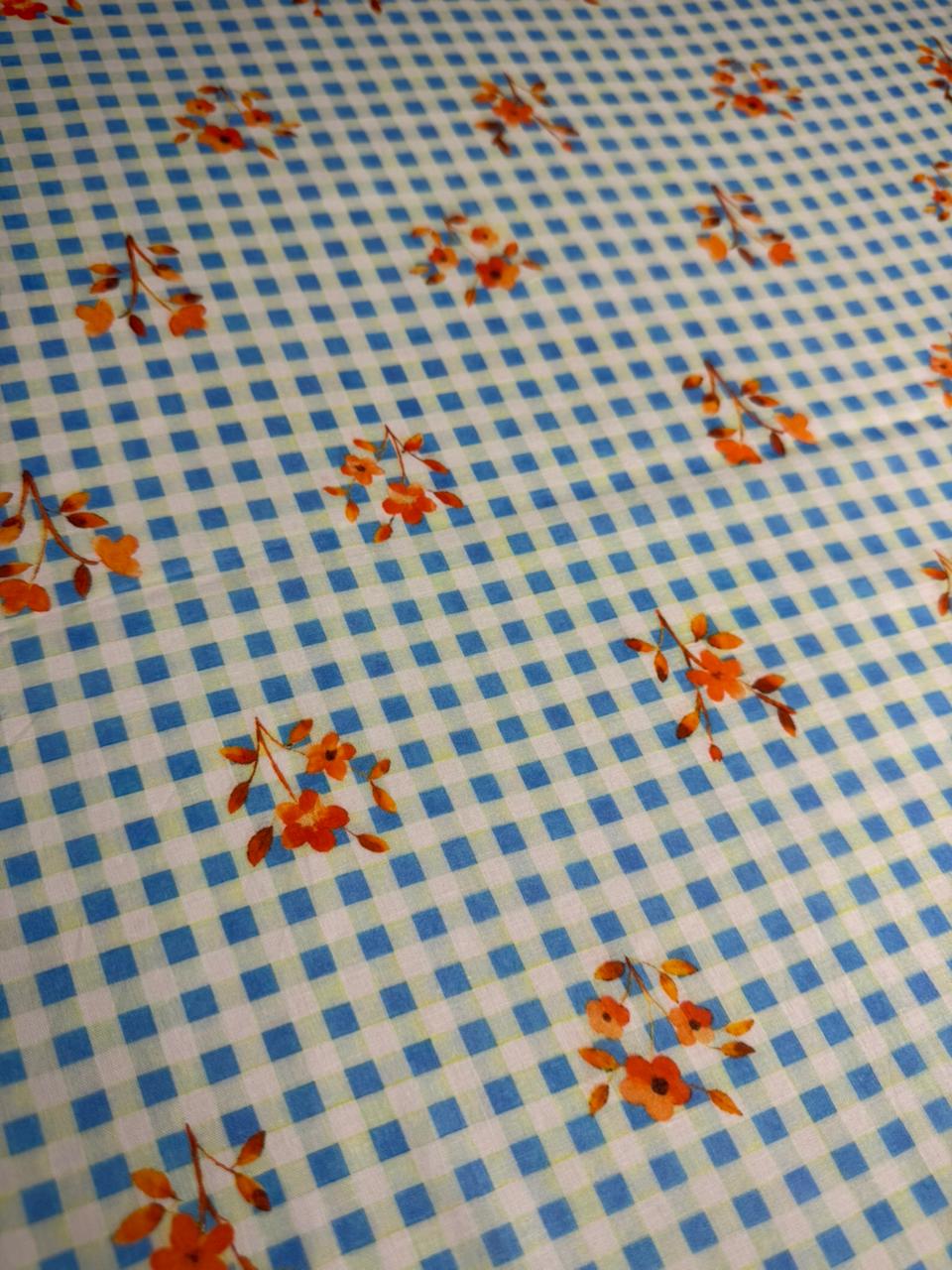 Fabric with blue checkered pattern and orange floral design