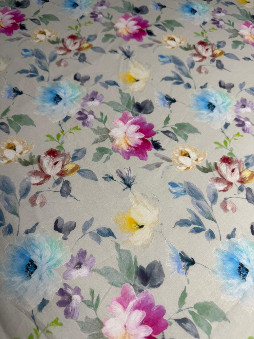Floral patterned fabric with colorful flowers on a light background
