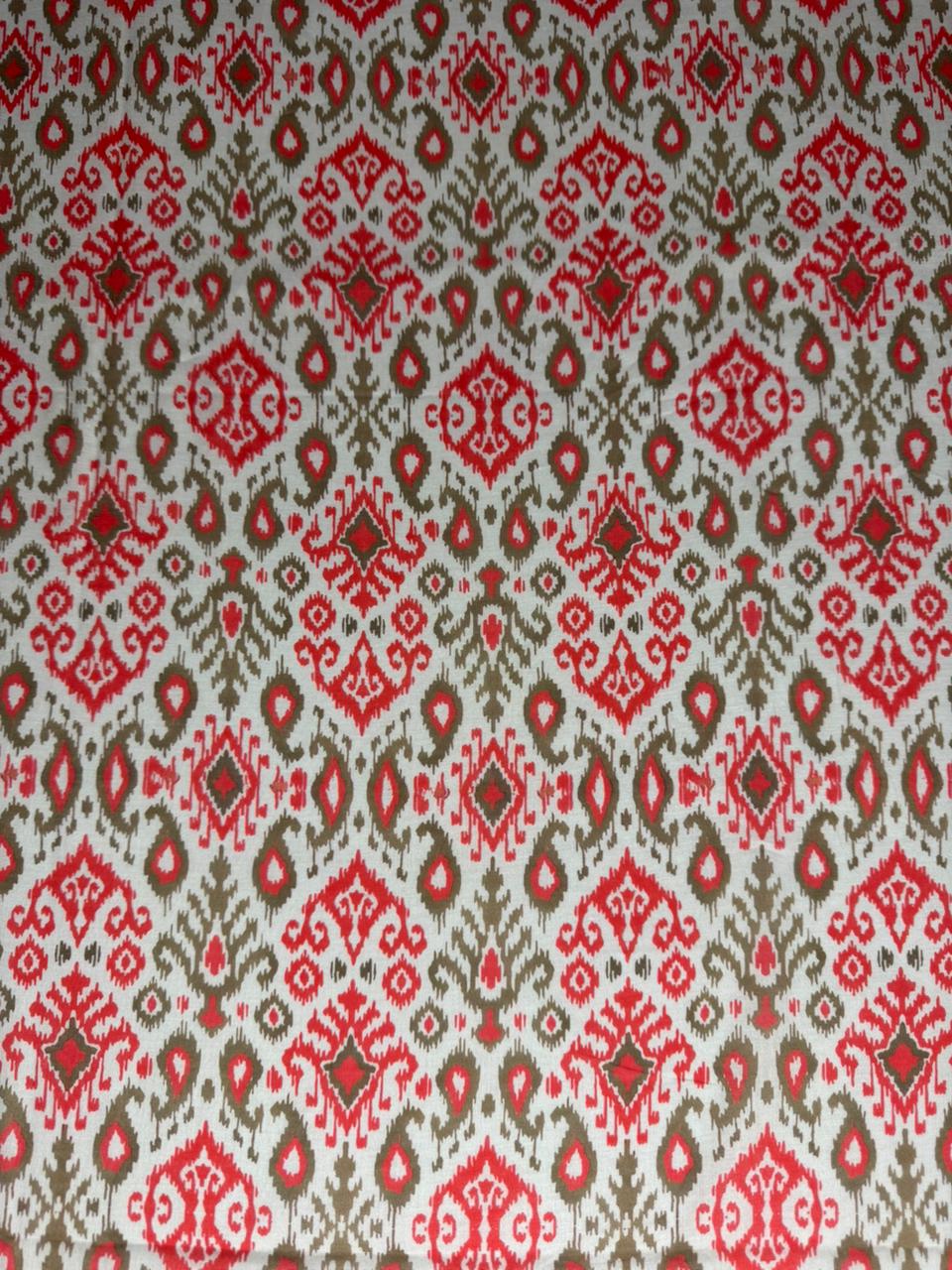 Patterned fabric with red and beige design on a white background
