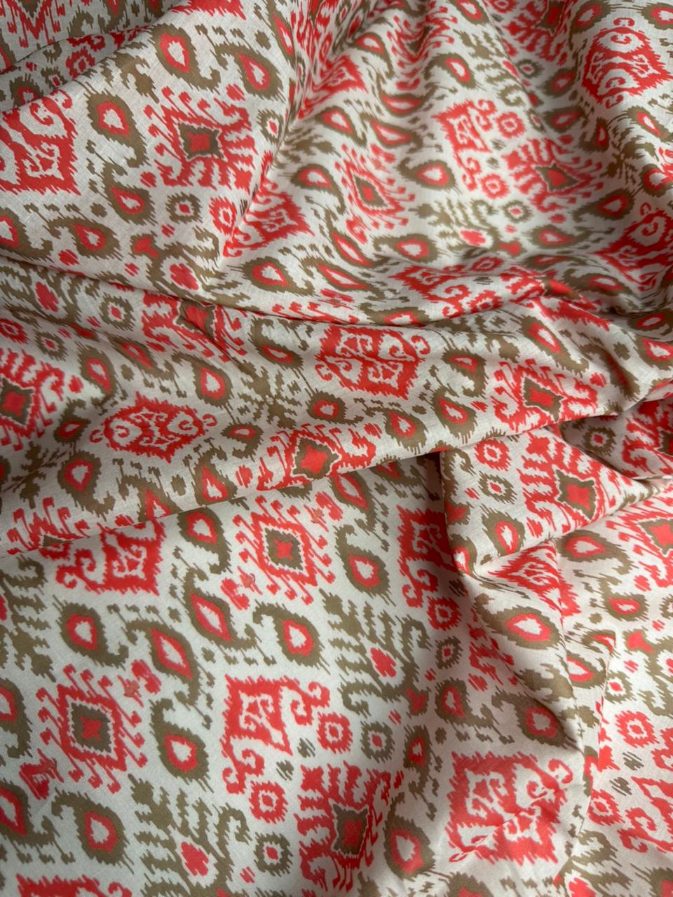 Close-up of patterned fabric with red and beige design
