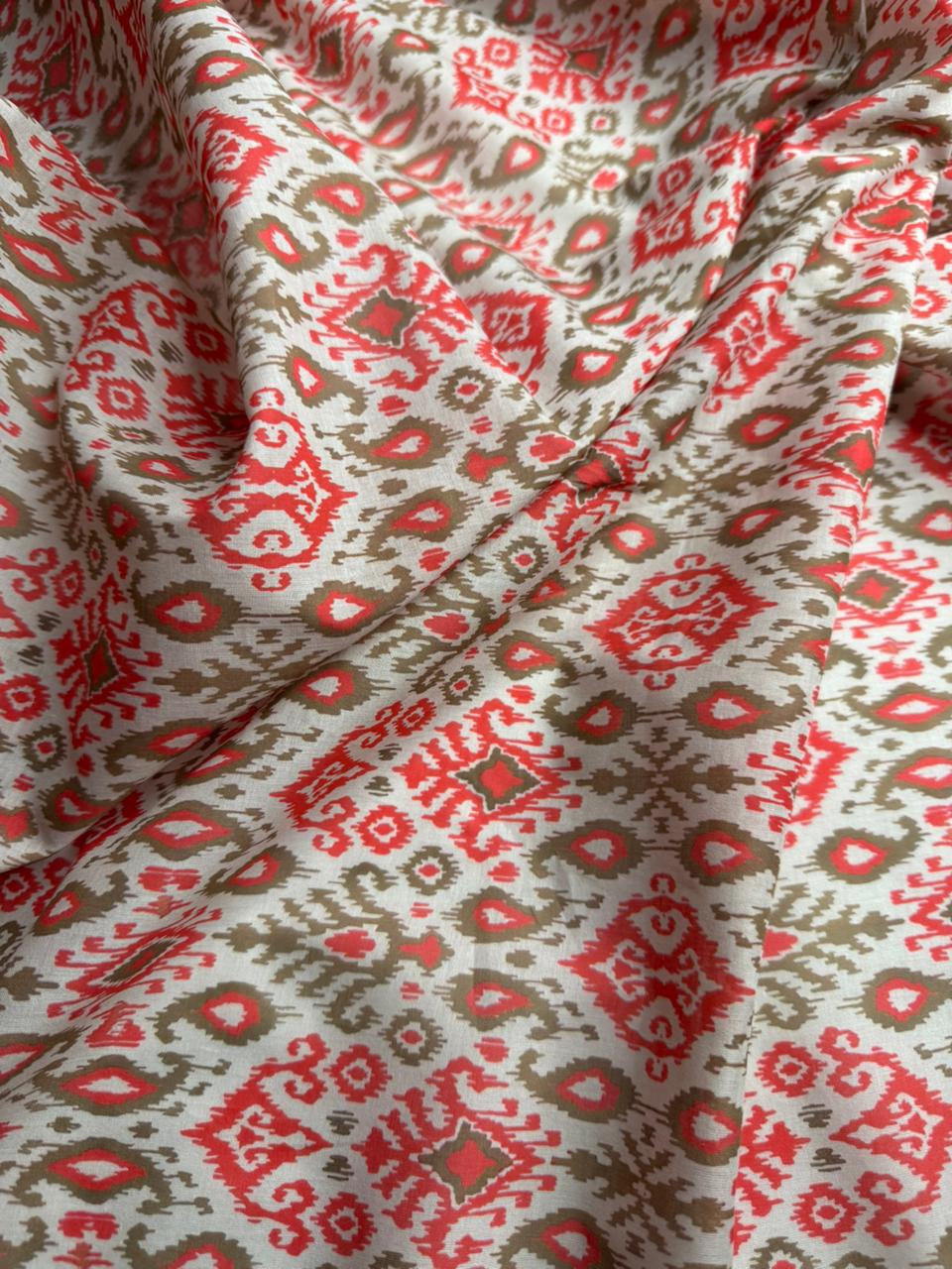 Close-up of patterned fabric with red and beige design