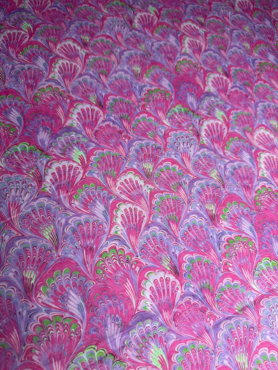 Patterned fabric with pink and purple peacock feather design