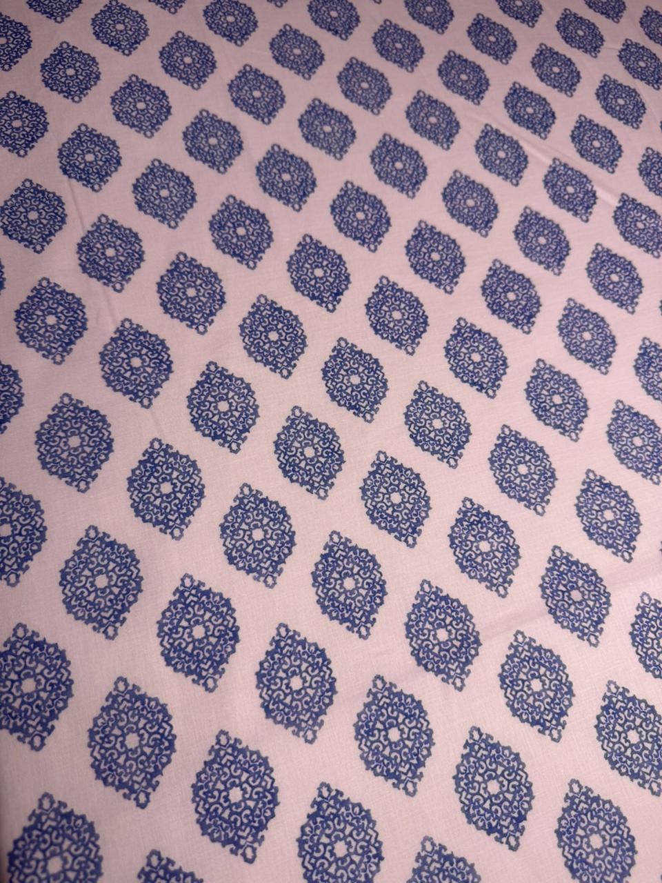 Patterned fabric with blue geometric design on a pink background