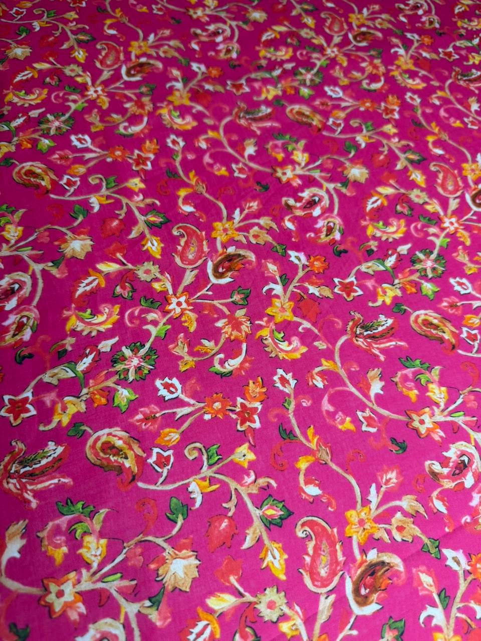 Floral patterned fabric on a pink background