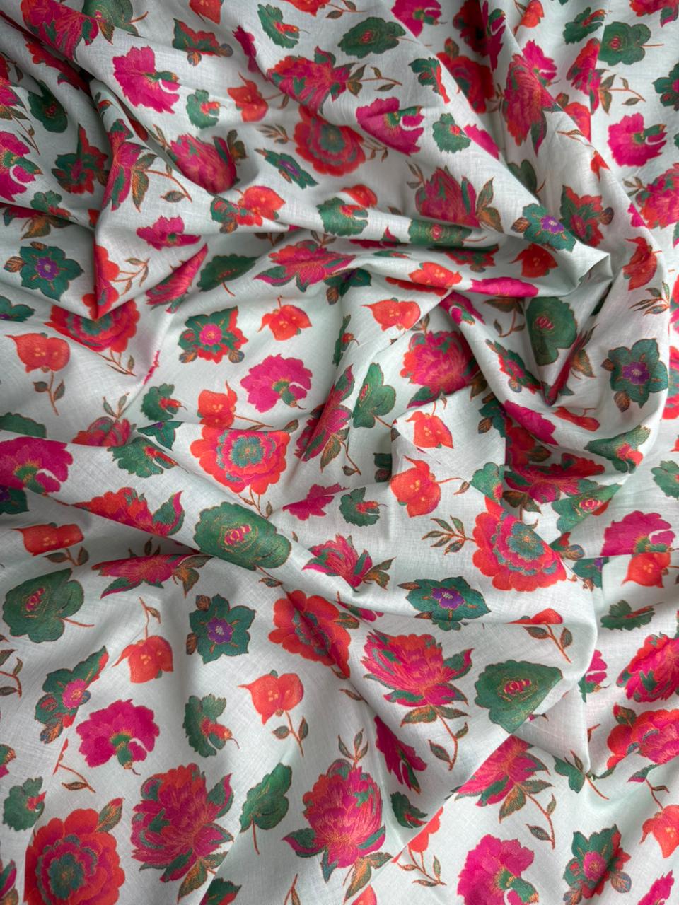 Floral fabric with red, pink, and green flowers on a white background