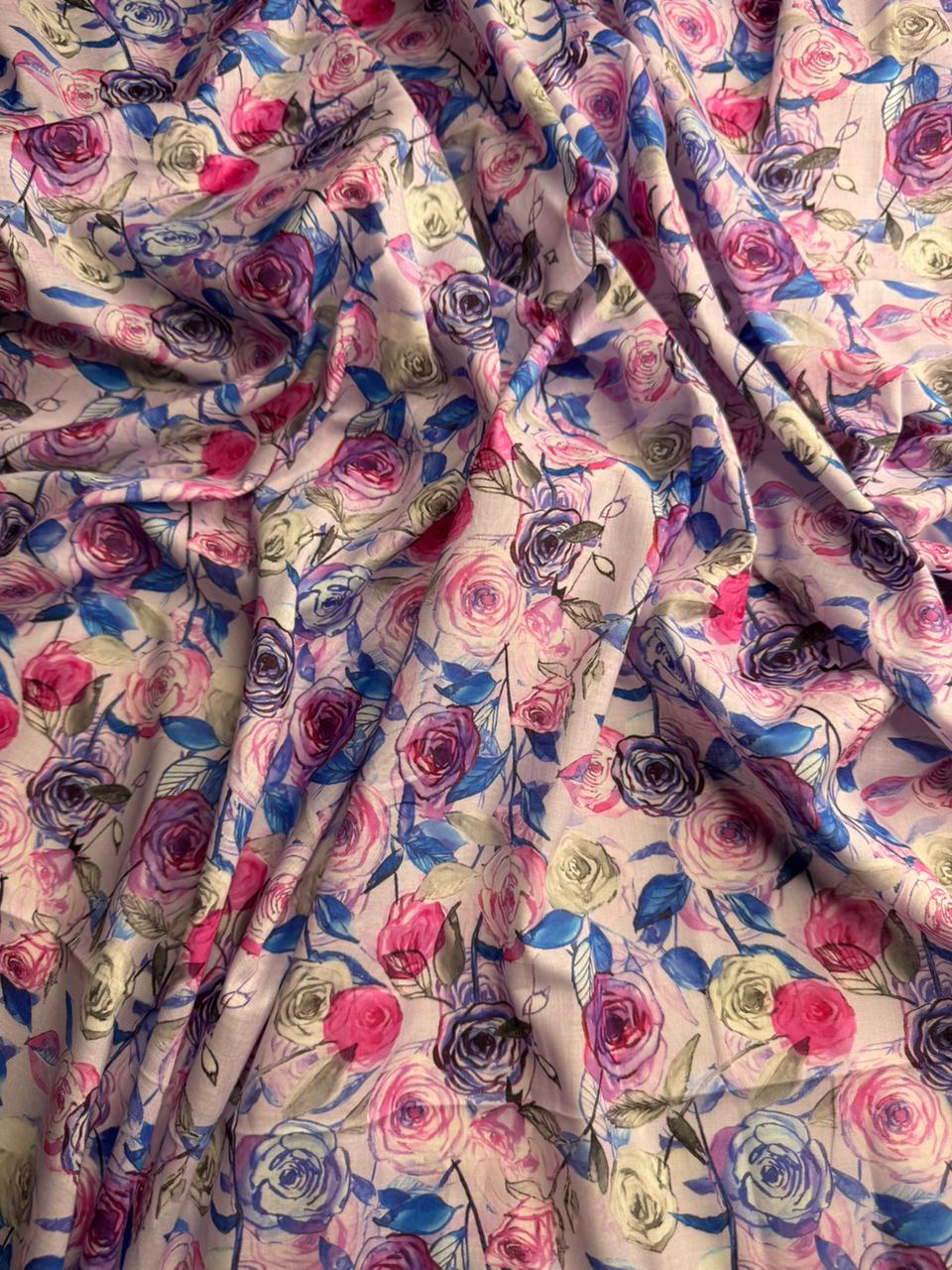 Floral fabric with pink, purple, and blue flowers on a white background