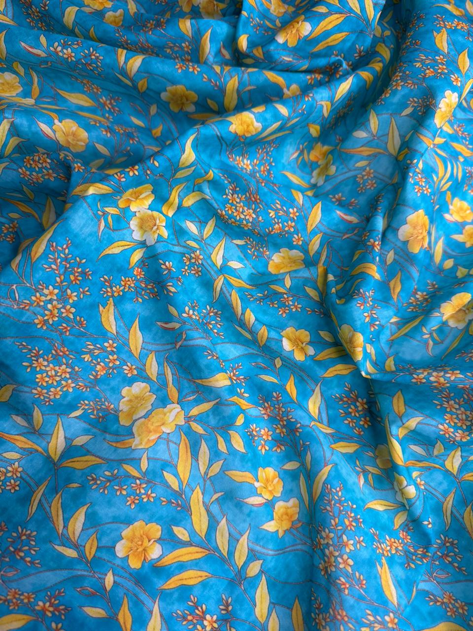 Floral patterned fabric with yellow flowers and leaves on a blue background