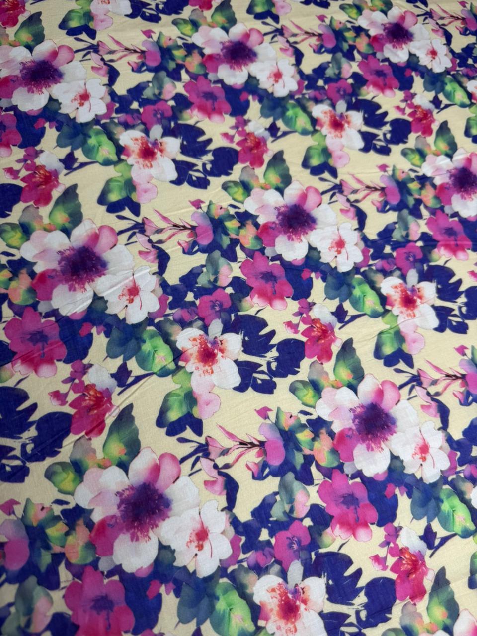 Floral fabric pattern with pink, purple, and green flowers on a yellow background