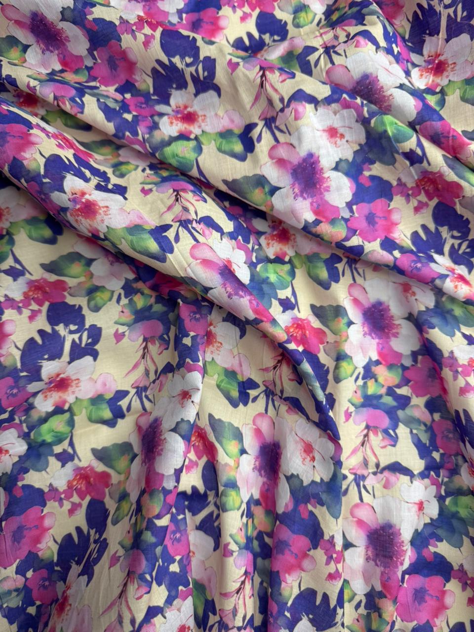 Multicolored floral fabric with pink, purple, and green flowers on a white background.