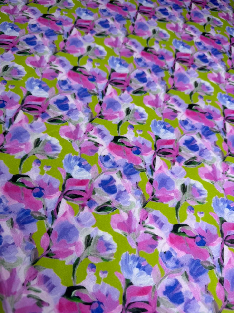 Floral pattern with pink and blue flowers on a green background
