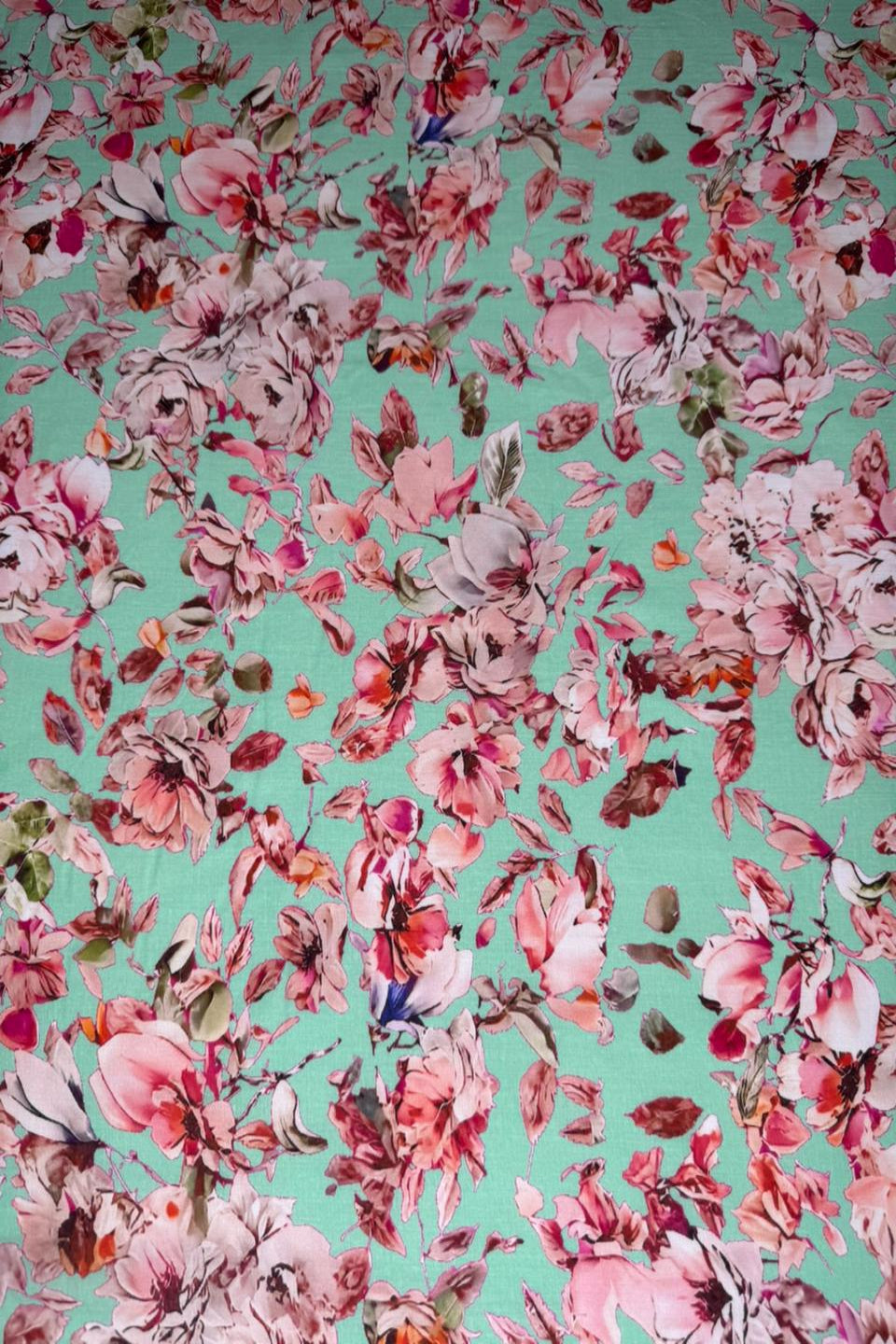 Floral pattern with pink and red flowers on a teal background