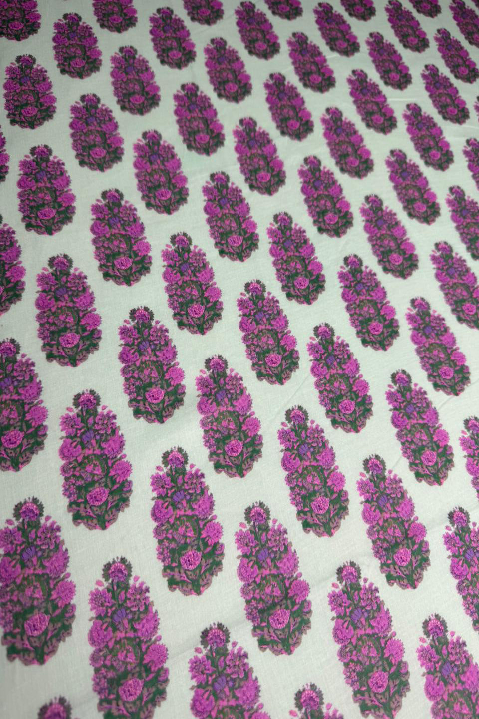 Pattern of pink and green floral designs on a white background