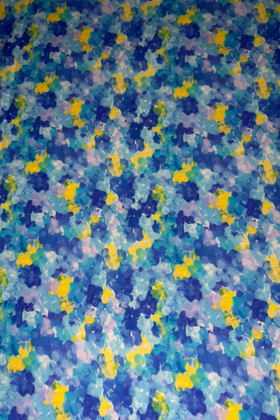 Multicolored abstract pattern with blue, yellow, and purple hues.
