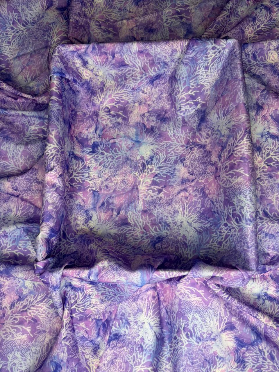 Floral patterned fabric with a purple and green color scheme