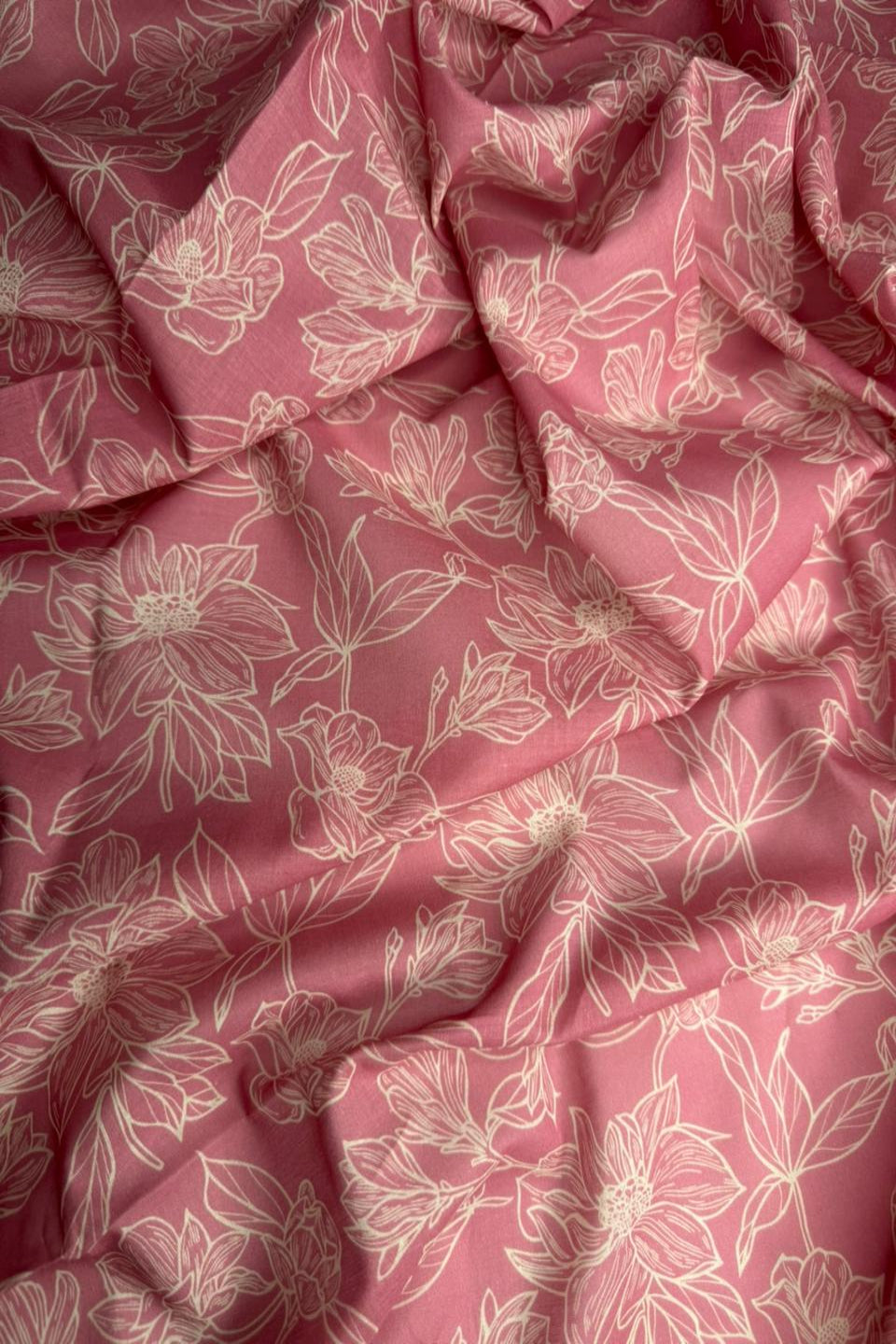 Pink fabric with white floral pattern
