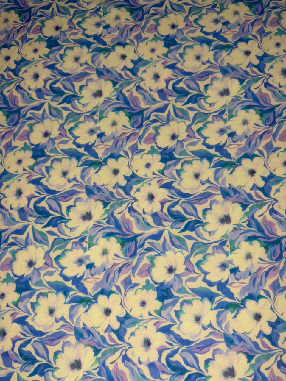Floral patterned fabric with white flowers on a blue background