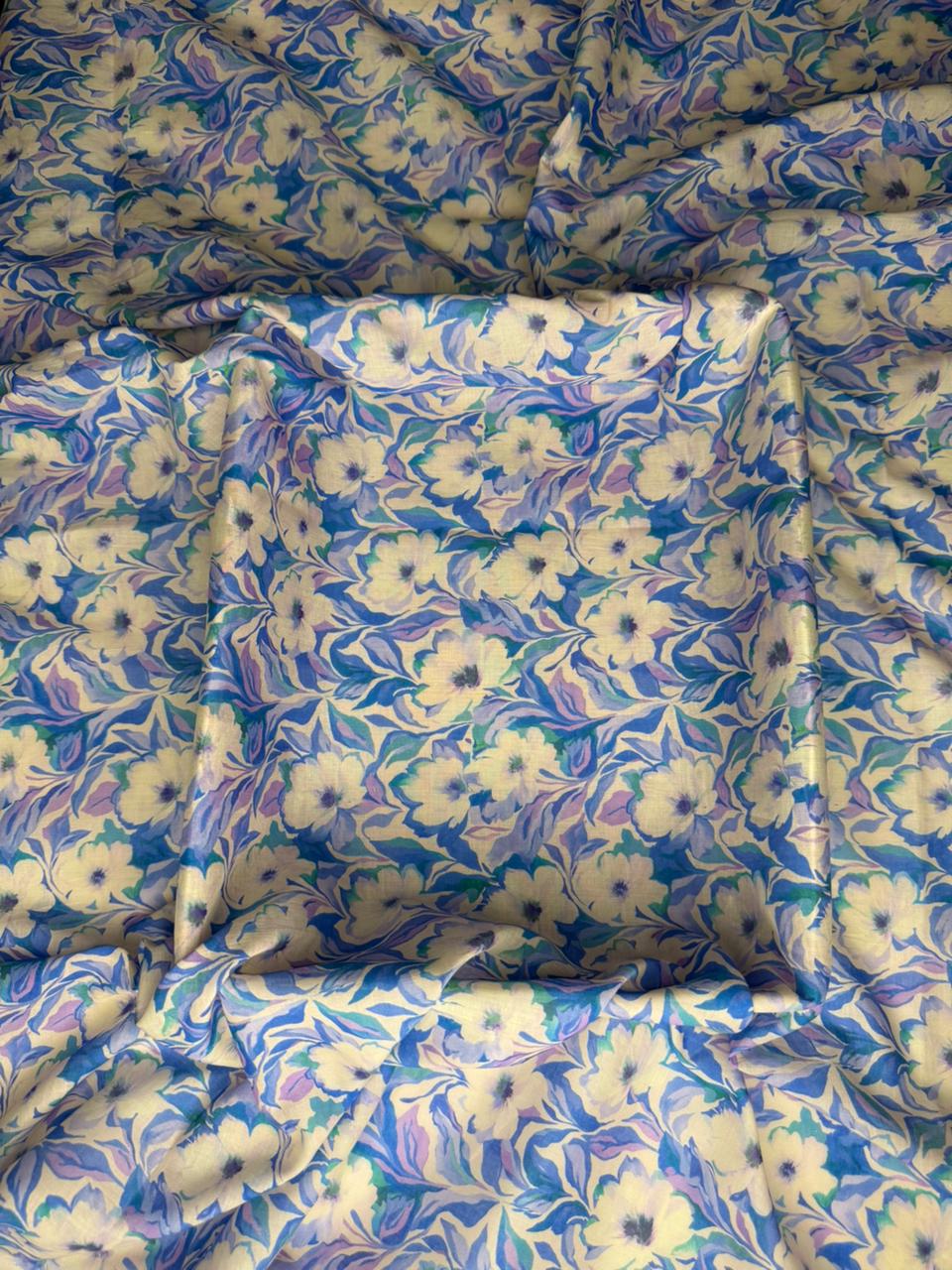 Floral patterned fabric with blue, white, and green colors.