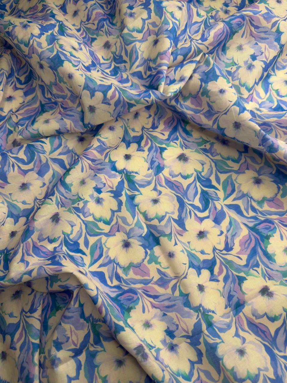 Floral fabric with blue and purple flowers on a white background