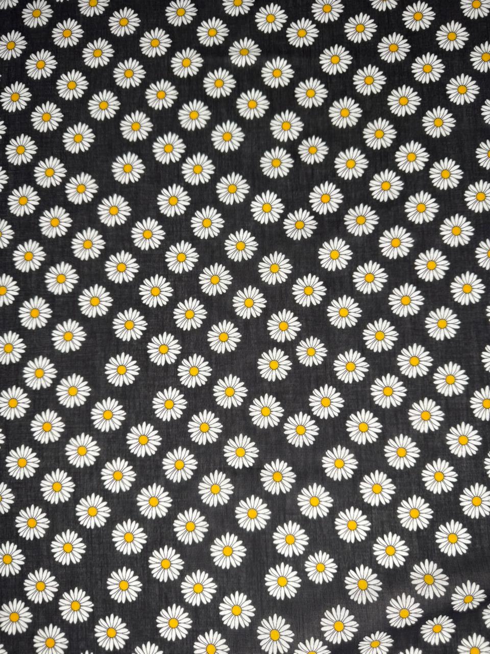 Pattern of white daisies with yellow centers on a black background