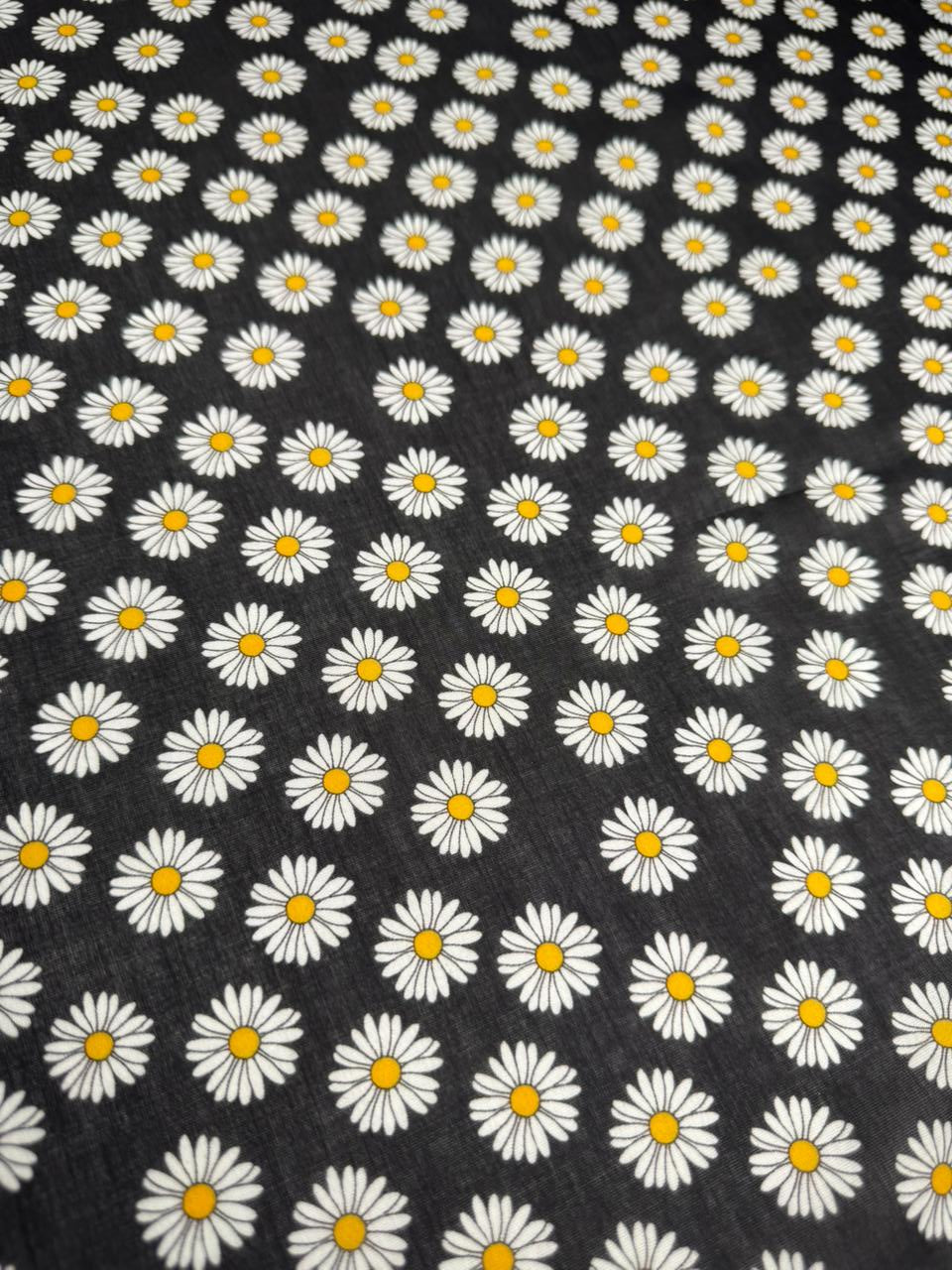 Pattern of white daisies with yellow centers on a black background