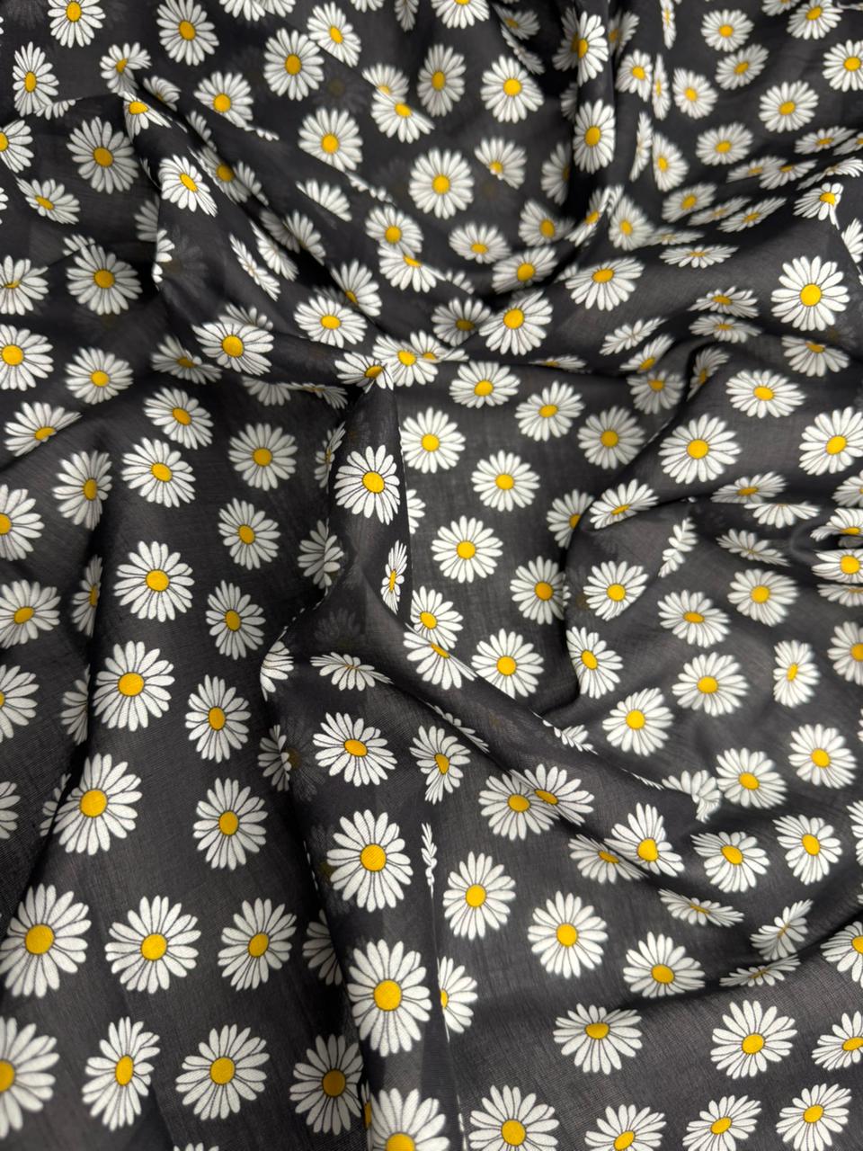 Fabric with daisy pattern on a dark background