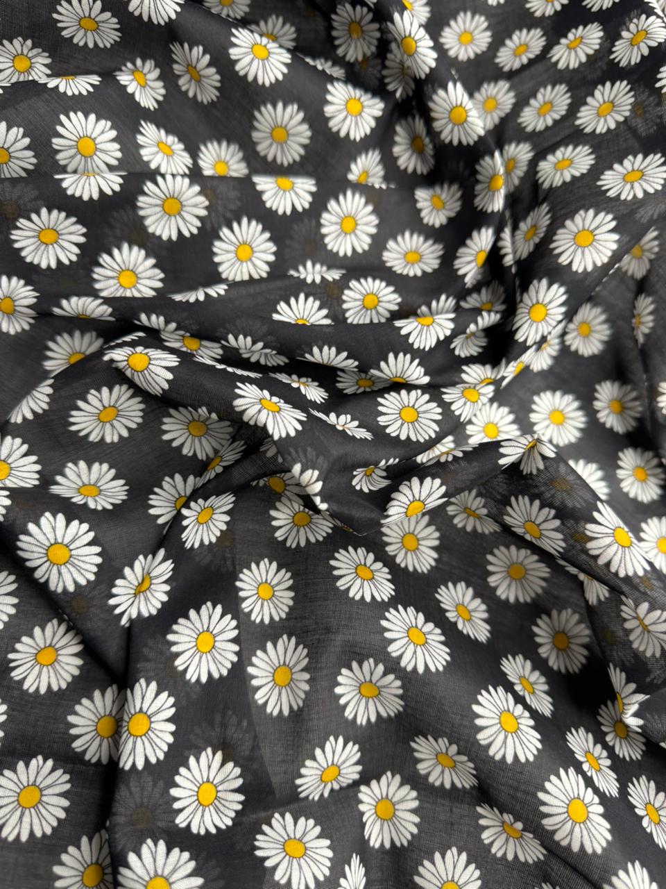 Fabric with daisy pattern on a black background