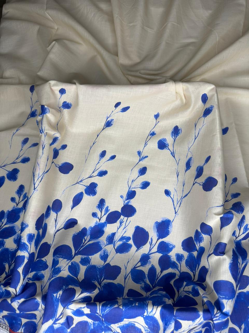 White fabric with blue floral pattern on a white background