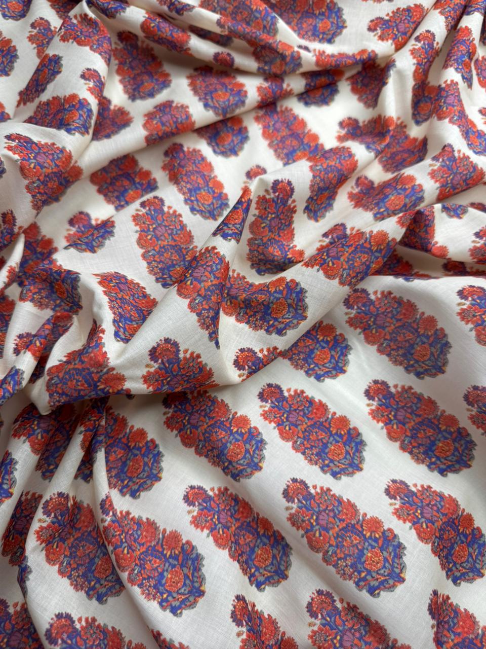 Floral patterned fabric with red and blue colors on a white background