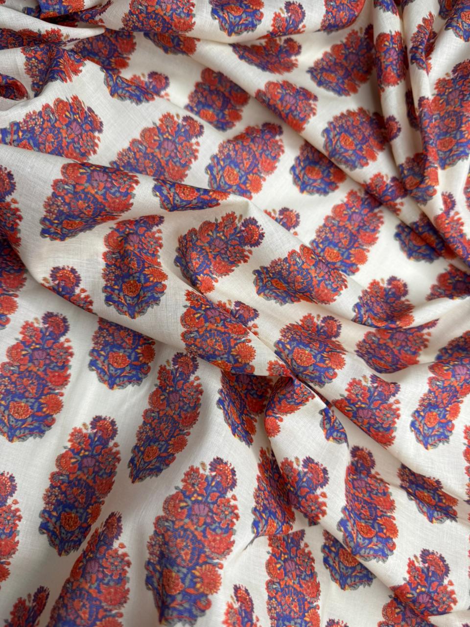 Fabric with red and blue floral pattern on a white background
