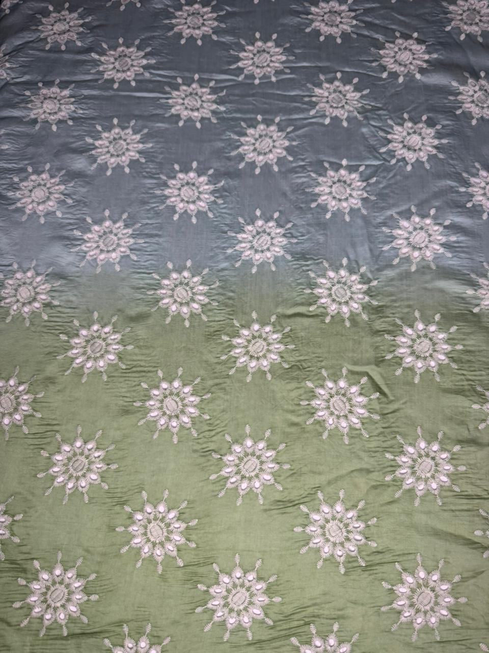 Fabric with floral patterns in two colors on a textured background