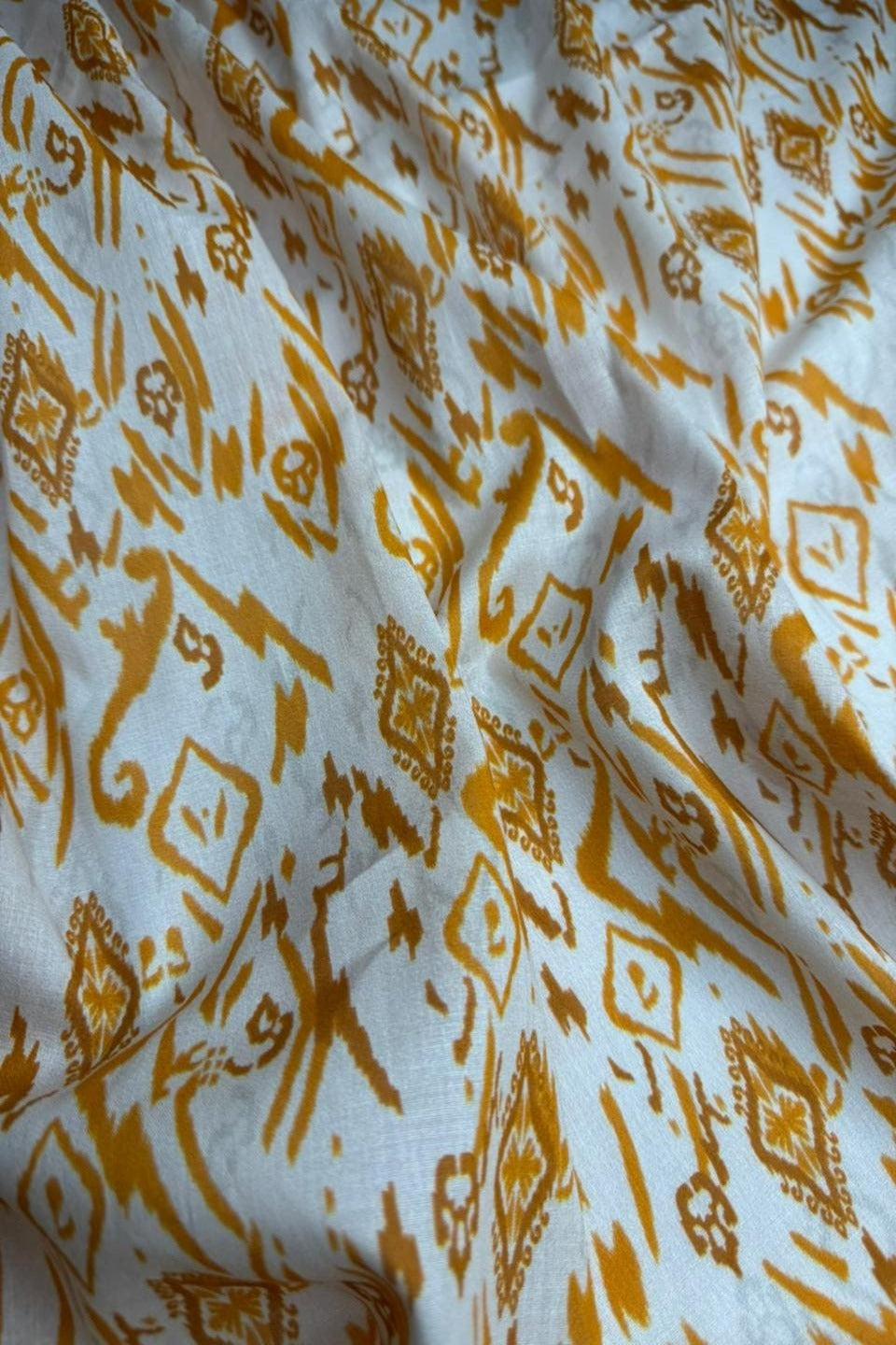 Fabric with yellow geometric pattern on a white background