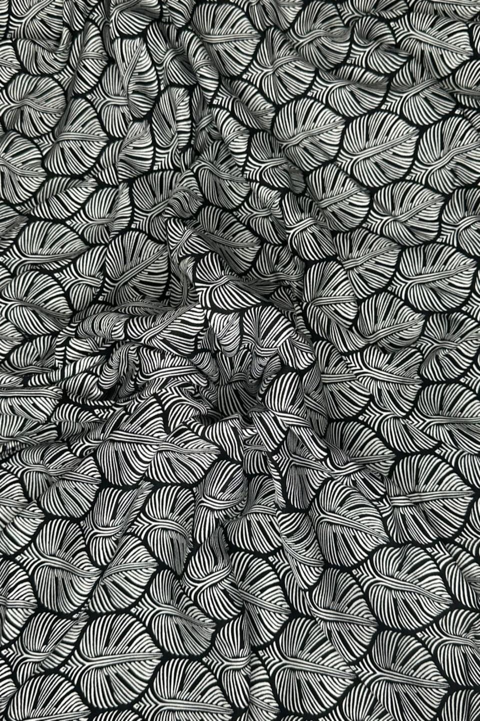 Black and white leaf pattern on a textured surface